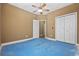 Bedroom with a ceiling fan, closet, and blue flooring ready for renovation at 197 Black Bear Rd., Myrtle Beach, SC 29588