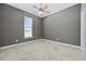 Bedroom with gray walls, neutral carpet, and a ceiling fan with a light at 197 Black Bear Rd., Myrtle Beach, SC 29588