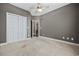Spacious bedroom features neutral carpet, gray walls and double white closet doors at 197 Black Bear Rd., Myrtle Beach, SC 29588