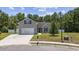 Charming home featuring manicured lawn, attached two-car garage, and neutral siding at 197 Black Bear Rd., Myrtle Beach, SC 29588