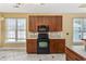 Bright kitchen with wood cabinetry, black oven, and window providing ample natural light at 197 Black Bear Rd., Myrtle Beach, SC 29588