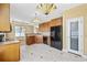 Traditional kitchen featuring wooden cabinets, tile flooring, and black appliances at 197 Black Bear Rd., Myrtle Beach, SC 29588