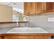 Close-up of the kitchen sink, featuring a stainless steel faucet and wood cabinetry at 197 Black Bear Rd., Myrtle Beach, SC 29588