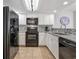Modern kitchen with white cabinetry, black appliances, and stylish backsplash, perfect for cooking and entertaining at 205 74Th Ave. N # 1508, Myrtle Beach, SC 29572