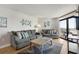 Cozy living room features comfortable seating and access to the balcony at 205 74Th Ave. N # 1508, Myrtle Beach, SC 29572
