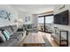Inviting living room featuring comfortable seating, a TV, and sliding glass doors to a balcony with ocean views at 205 74Th Ave. N # 1508, Myrtle Beach, SC 29572