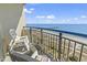 Balcony view of the beach with chairs, table, and railings at 2300 N Ocean Blvd. # 1037, Myrtle Beach, SC 29577
