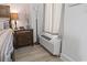 Cozy bedroom detail showcasing a nightstand, lamp, and a glimpse of the window air conditioner at 2300 N Ocean Blvd. # 1037, Myrtle Beach, SC 29577