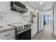 Modern kitchen featuring stainless steel appliances, white cabinetry, and beautiful tile backsplash at 2300 N Ocean Blvd. # 1037, Myrtle Beach, SC 29577