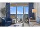 Well-lit living room offers a comfortable sitting area and expansive views from the sliding glass door at 2300 N Ocean Blvd. # 1037, Myrtle Beach, SC 29577