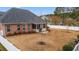 An inviting backyard features a brick home, screened porch, mature trees, and a white picket fence at 2350 Clandon Dr., Myrtle Beach, SC 29579