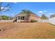 A charming brick home features a screened porch and well-maintained yard, perfect for outdoor living at 2350 Clandon Dr., Myrtle Beach, SC 29579