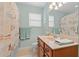 This bathroom has a single sink vanity, large mirror, and a shower/tub combo with curtain at 2350 Clandon Dr., Myrtle Beach, SC 29579