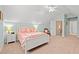 This bright bedroom features a white bed frame, sloped ceiling, ceiling fan, and ensuite bath access at 2350 Clandon Dr., Myrtle Beach, SC 29579