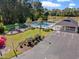 Aerial view of a community pool with a playground, pavilion, and parking area surrounded by landscaping at 2350 Clandon Dr., Myrtle Beach, SC 29579