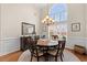 Dining room with a large arched window, chandelier, wood table, and hardwood floors at 2350 Clandon Dr., Myrtle Beach, SC 29579