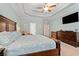 The bright main bedroom features a king bed with blue seashell bedding, wood furniture, and ensuite bath access at 2350 Clandon Dr., Myrtle Beach, SC 29579