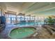 Indoor pool area with a hot tub, seating, and large windows offering ocean views at 2401 S Ocean Blvd. # 1260, Myrtle Beach, SC 29577
