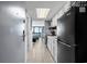 Galley kitchen with white cabinets and black appliances overlooking ocean view at 2401 S Ocean Blvd. # 1260, Myrtle Beach, SC 29577