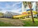 Waterslide attached to the building with lush green grass and trees at 2401 S Ocean Blvd. # 1260, Myrtle Beach, SC 29577