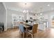 Elegant dining room with a wood table, modern lighting, and a seamless transition to the kitchen at 2416 Campton Loop, Conway, SC 29527
