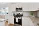 Close-up of kitchen with stainless steel appliances, granite countertops, and white cabinetry at 2416 Campton Loop, Conway, SC 29527