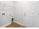Functional laundry room features washer/dryer hookups, overhead shelving, and durable wood-look flooring at 2416 Campton Loop, Conway, SC 29527