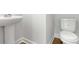 Bright half-bath featuring a pedestal sink, toilet, and wood-look flooring at 2420 Campton Loop, Conway, SC 29527