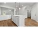 Bright kitchen island with modern cabinets and hardwood floors at 2420 Campton Loop, Conway, SC 29527