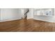 Open concept living area featuring wood floors, a staircase, and an eat-in kitchen at 2420 Campton Loop, Conway, SC 29527