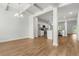 Bright and airy living room featuring an open floor plan, wood floors, and a coffered ceiling at 2420 Campton Loop, Conway, SC 29527