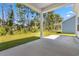 Relaxing covered patio overlooking a lawn and a border of beautiful, mature trees at 2420 Campton Loop, Conway, SC 29527