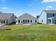 Backyard view of a new construction home with a manicured lawn at 2424 Campton Loop, Conway, SC 29527