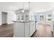 Spacious kitchen with stainless steel appliances and island overlooking an open-concept living area at 2424 Campton Loop, Conway, SC 29527