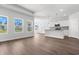 Bright and airy living room with wood floors and an open layout, connecting seamlessly to the kitchen at 2424 Campton Loop, Conway, SC 29527