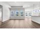 Bright, open-concept living room with hardwood floors and natural light from multiple windows at 2424 Campton Loop, Conway, SC 29527