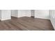 Neutral living room with attractive hardwood floors, base trim, and white walls at 2424 Campton Loop, Conway, SC 29527