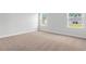 Neutral color bedroom featuring plush carpet, white trim, and two large windows at 2443 Campton Loop, Conway, SC 29527