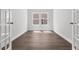 An airy room with hardwood floors, white walls, and sunlight streaming through the window at 2443 Campton Loop, Conway, SC 29527