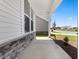 Inviting front porch featuring stone accents and views of the neighborhood at 2443 Campton Loop, Conway, SC 29527