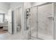 Elegant bathroom featuring a tiled shower with a bench and a view into the toilet room and bedroom at 2476 Blue Crane Circle # 101, Myrtle Beach, SC 29577