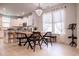 Elegant dining area featuring a chandelier, large windows, and a view of the kitchen at 2476 Blue Crane Circle # 101, Myrtle Beach, SC 29577