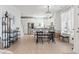 Dining area featuring chandelier lighting, wood floors, and large windows at 2476 Blue Crane Circle # 101, Myrtle Beach, SC 29577