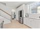 Kitchen area with stainless steel refrigerator and staircase at 2476 Blue Crane Circle # 101, Myrtle Beach, SC 29577
