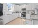 Bright kitchen featuring white cabinets, stainless steel appliances and light wood floors at 2476 Blue Crane Circle # 101, Myrtle Beach, SC 29577