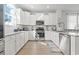 Well-lit kitchen featuring white cabinets, stainless steel appliances and light wood floors at 2476 Blue Crane Circle # 101, Myrtle Beach, SC 29577