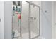 Modern tiled shower with glass door and built-in shelving in bright bathroom at 2476 Blue Crane Circle # 101, Myrtle Beach, SC 29577