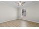 Bright bedroom with a ceiling fan, wood-look floors, and a window letting in plenty of natural light at 2483 Morlynn Dr., Myrtle Beach, SC 29577