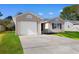 Charming single-story home with a concrete driveway and attached garage and green lawn at 2483 Morlynn Dr., Myrtle Beach, SC 29577