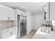 Updated kitchen showcasing stainless steel refrigerator, granite counters, white cabinets, and tile backsplash at 2483 Morlynn Dr., Myrtle Beach, SC 29577